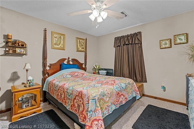 bedroom with ceiling fan, light carpet, and a textured ceiling