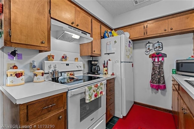 kitchen with a textured ceiling and white appliances