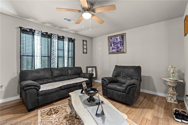 living room with ceiling fan and hardwood / wood-style flooring