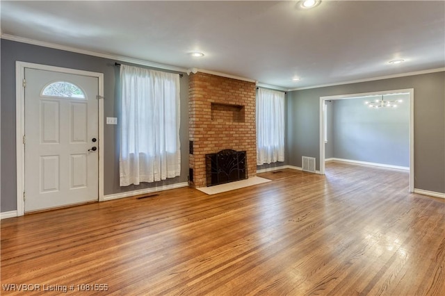 70 Haven Dr, Fort Smith, AR 72901 - unfurnished living room featuring wood finished floors, crown molding, a fireplace, a chandelier, and baseboards