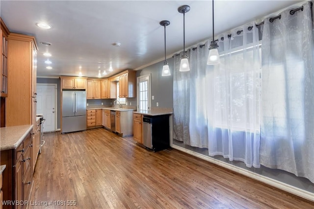 70 Haven Dr, Fort Smith, AR 72901 - kitchen with stainless steel appliances, light countertops, light wood finished floors, ornamental molding, and decorative light fixtures