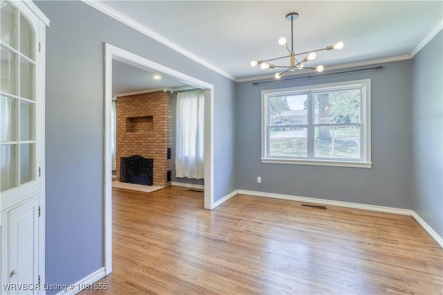 70 Haven Dr, Fort Smith, AR 72901 - unfurnished dining area with a chandelier, crown molding, light wood-style flooring, a brick fireplace, and baseboards
