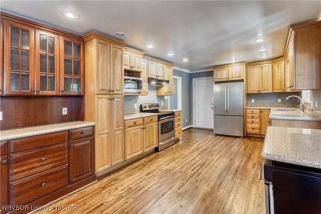 70 Haven Dr, Fort Smith, AR 72901 - kitchen featuring stainless steel appliances, under cabinet range hood, a sink, light stone countertops, and light wood-style flooring
