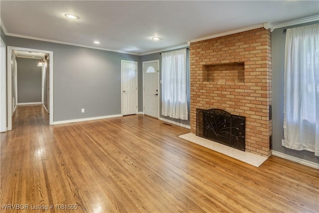 70 Haven Dr, Fort Smith, AR 72901 - unfurnished living room with baseboards, wood finished floors, healthy amount of natural light, a brick fireplace, and crown molding