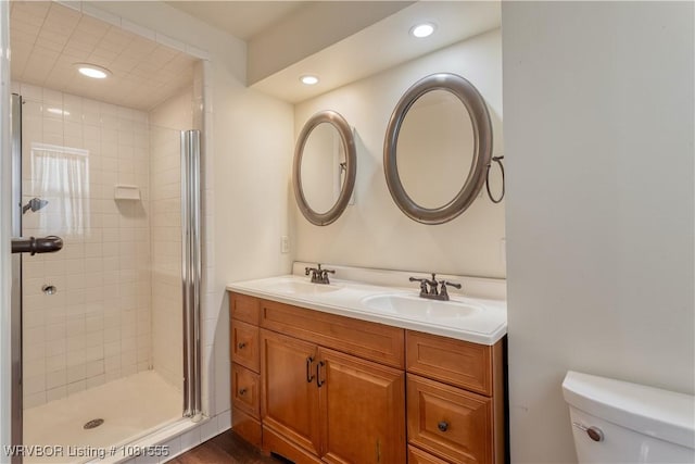 70 Haven Dr, Fort Smith, AR 72901 - full bathroom with toilet, double vanity, a stall shower, recessed lighting, and wood finished floors