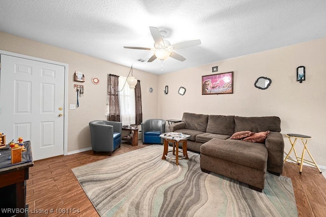 112179 S 4776th Rd, Muldrow, OK 74948 - living area with a ceiling fan, wood finished floors, baseboards, and a textured ceiling