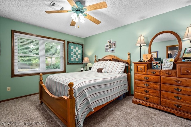 bedroom featuring light carpet, a textured ceiling, and ceiling fan