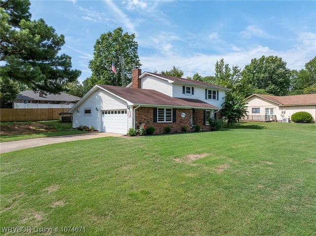 view of front of house with a front yard and a garage