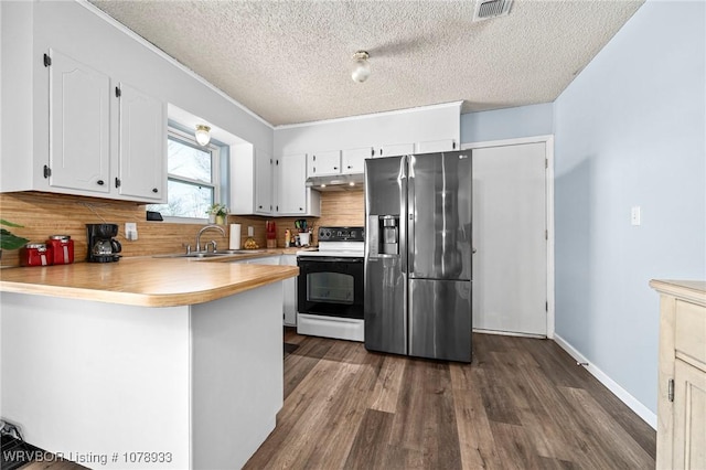 kitchen featuring electric stove, stainless steel refrigerator with ice dispenser, light countertops, and white cabinetry