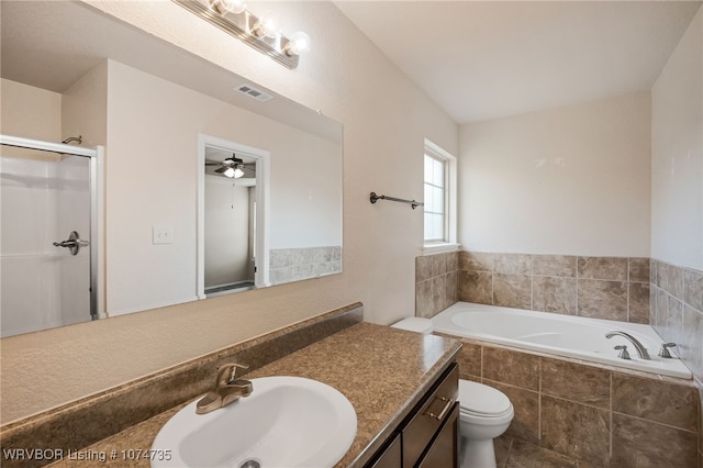 full bathroom featuring vanity, toilet, ceiling fan, and separate shower and tub