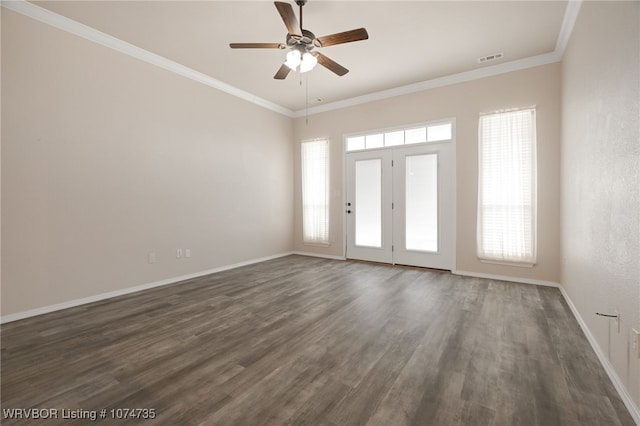 spare room featuring crown molding, ceiling fan, and dark wood-type flooring