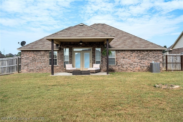 back of property featuring an outdoor living space, ceiling fan, central AC unit, a patio area, and a lawn