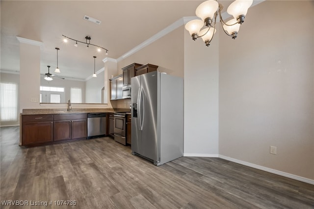 kitchen featuring appliances with stainless steel finishes, ornamental molding, ceiling fan with notable chandelier, sink, and hanging light fixtures