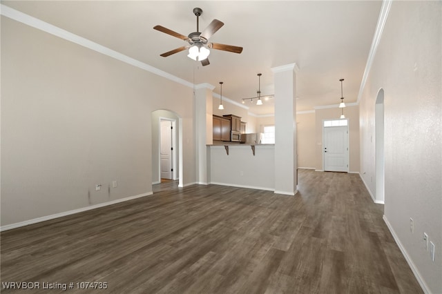 unfurnished living room featuring crown molding, ceiling fan, and dark wood-type flooring