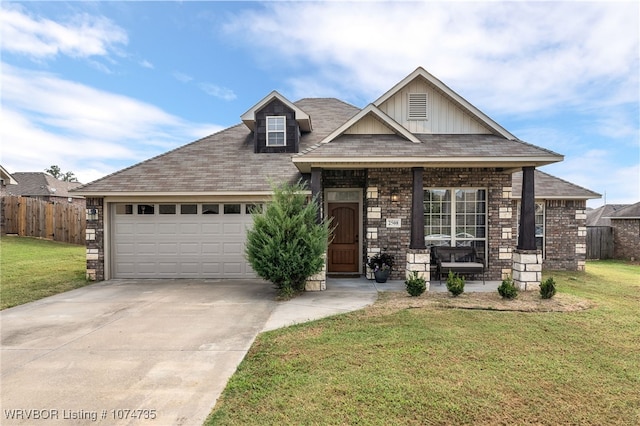 view of front facade featuring a front yard, a porch, and a garage