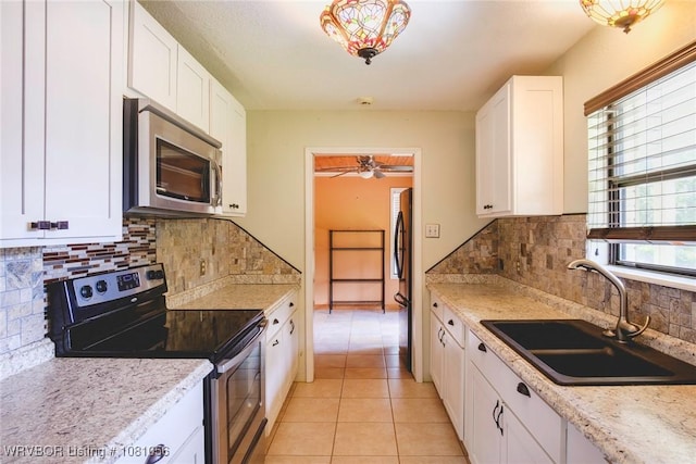 1515 M Cir, Barling, AR 72923 - kitchen featuring stainless steel appliances, a sink, white cabinets, and light tile patterned floors