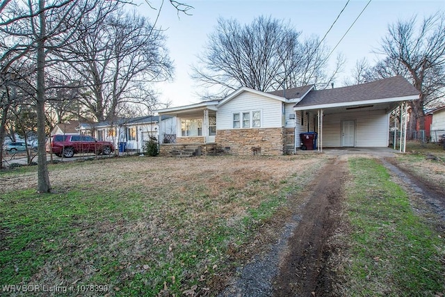 ranch-style house with a carport and covered porch