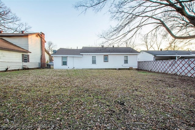 rear view of property featuring a yard