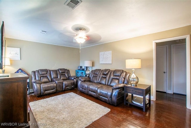 living room featuring dark wood-type flooring and ceiling fan