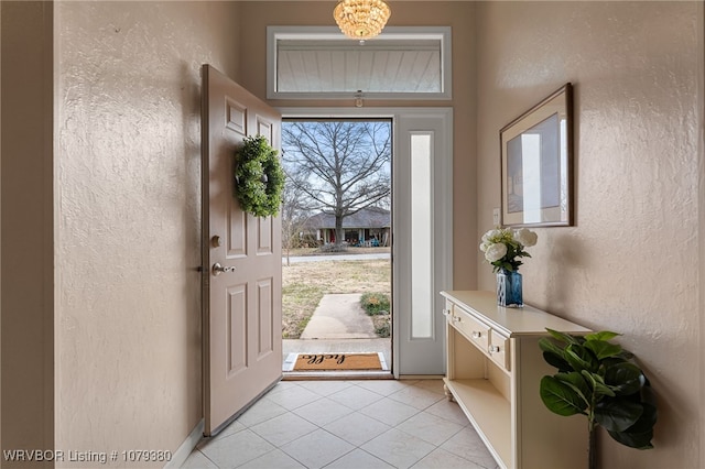 doorway featuring light tile patterned flooring and a textured wall