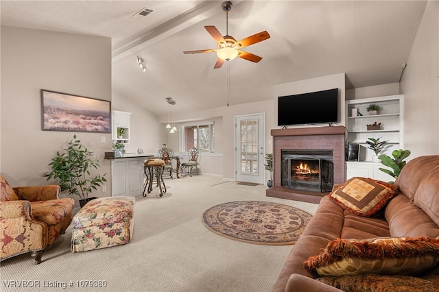 carpeted living area featuring beam ceiling, a fireplace, visible vents, a ceiling fan, and high vaulted ceiling