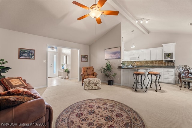 living room featuring beam ceiling, a ceiling fan, light carpet, high vaulted ceiling, and baseboards