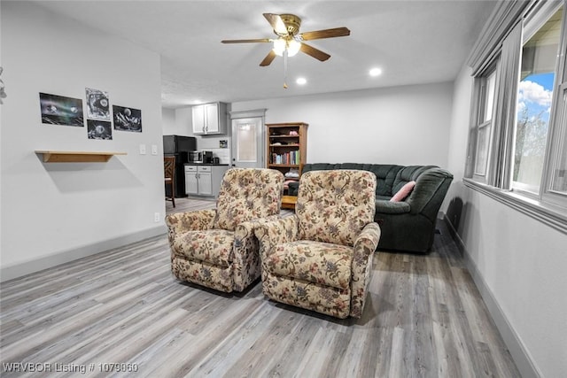 living area featuring light wood-style floors, recessed lighting, ceiling fan, and baseboards