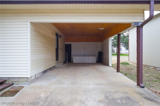 exterior space with an attached carport and concrete driveway