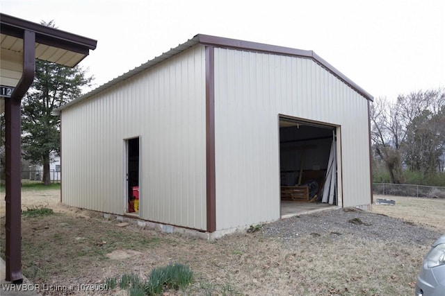 view of pole building featuring fence