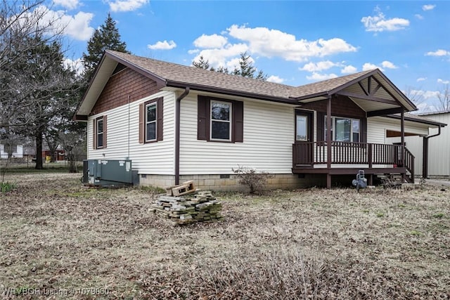 ranch-style house with crawl space, roof with shingles, and central air condition unit