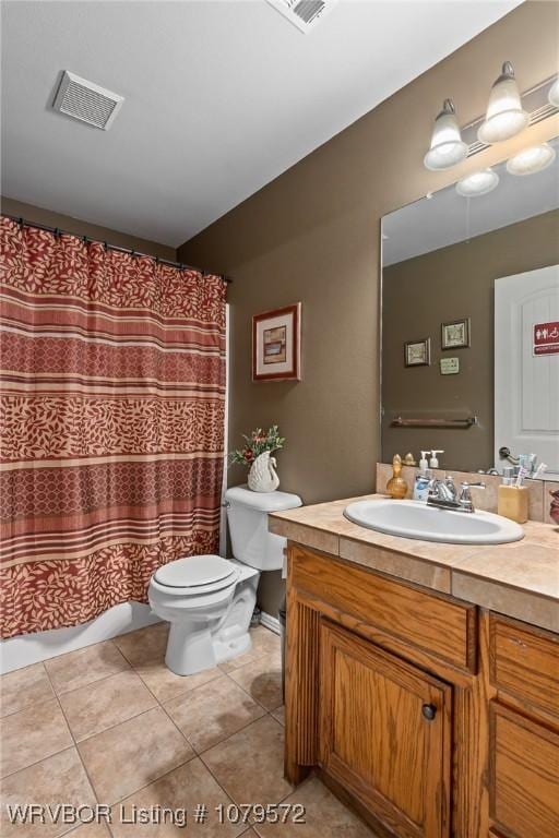 bathroom with vanity, tile patterned floors, toilet, and visible vents