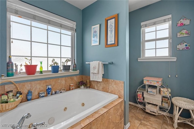 full bathroom with a wealth of natural light, baseboards, a jetted tub, and tile patterned flooring