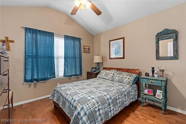 bedroom with baseboards, wood finished floors, and vaulted ceiling