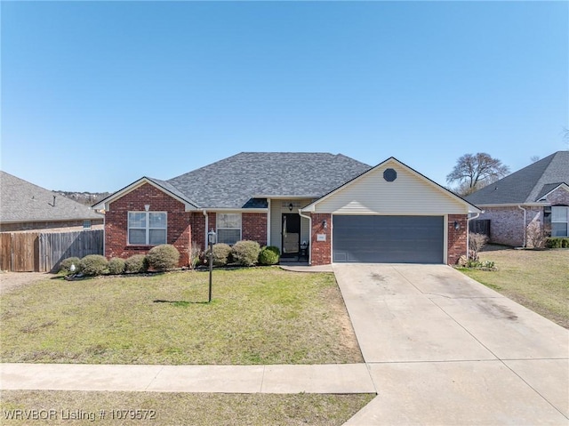 ranch-style house with a garage, brick siding, a front lawn, and fence