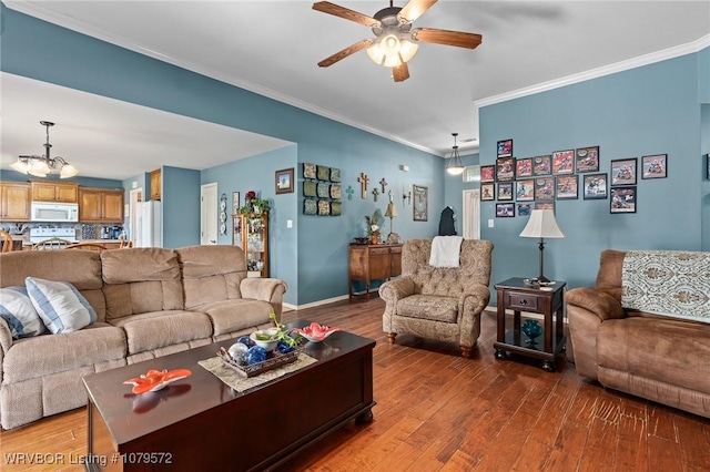 living room with ceiling fan with notable chandelier, crown molding, baseboards, and hardwood / wood-style flooring