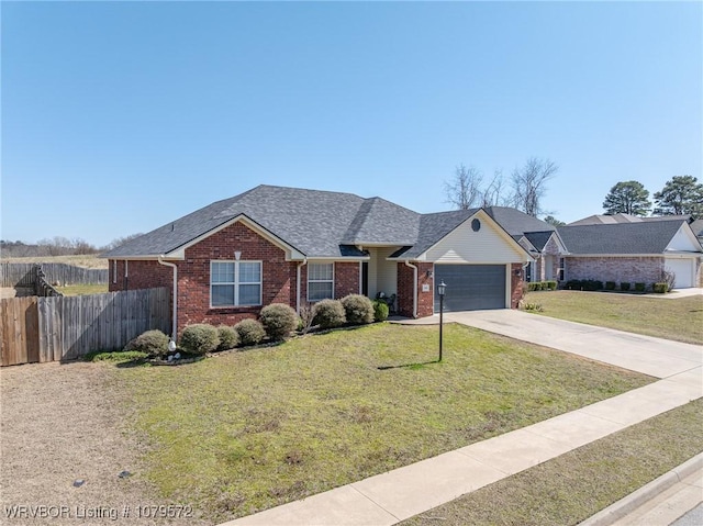 single story home with fence, driveway, an attached garage, a front lawn, and brick siding