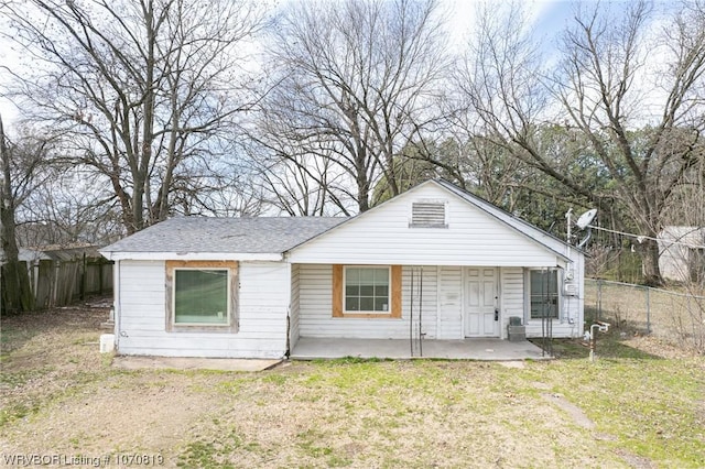 rear view of property featuring a lawn and a patio