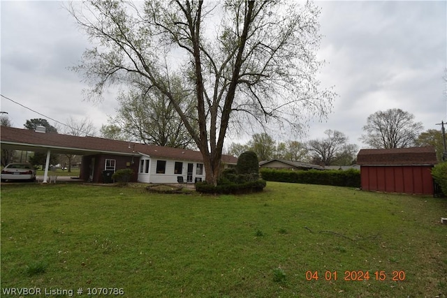 view of yard with a storage unit and a carport