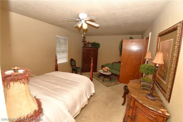 carpeted bedroom featuring a textured ceiling and ceiling fan