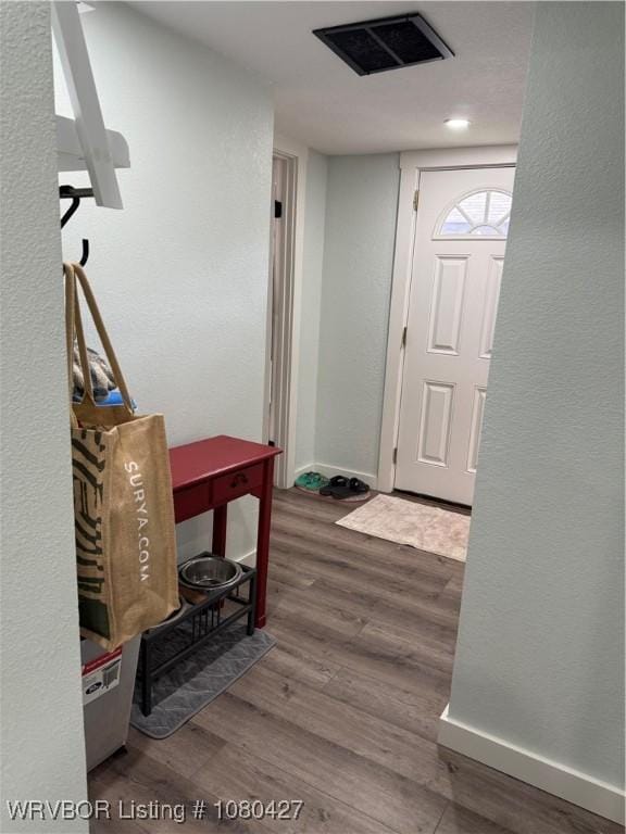 306 Hayes St, Clarksville, AR 72830 - foyer with baseboards, a textured wall, wood finished floors, and visible vents