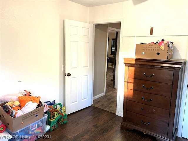 bedroom featuring baseboards and dark wood finished floors