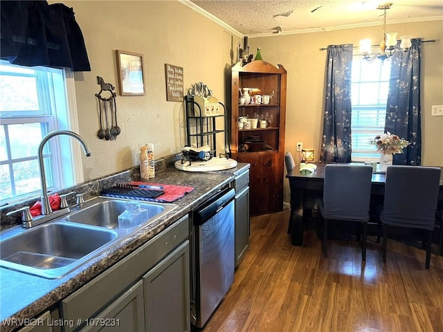 kitchen with dark wood finished floors, stainless steel dishwasher, ornamental molding, a sink, and a textured ceiling