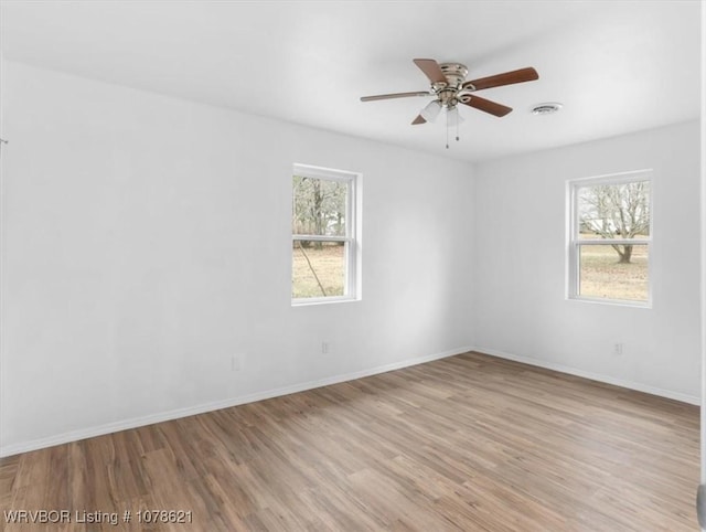 empty room with light hardwood / wood-style floors and ceiling fan