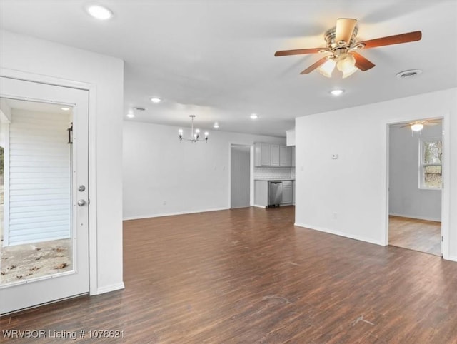 unfurnished living room with dark hardwood / wood-style floors and ceiling fan with notable chandelier