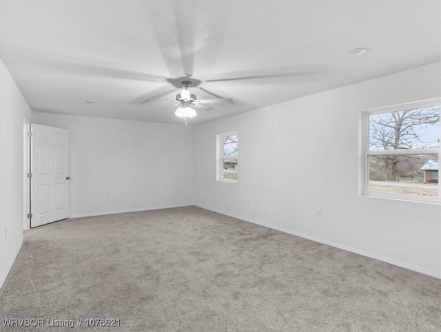 empty room with ceiling fan and light colored carpet