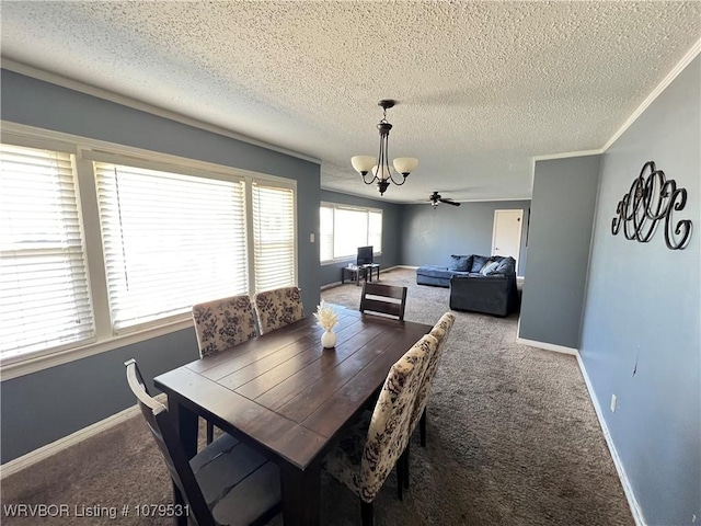 dining room with ceiling fan with notable chandelier, a textured ceiling, carpet floors, crown molding, and baseboards