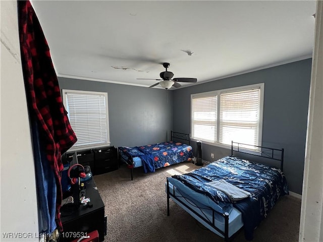 bedroom featuring a ceiling fan, carpet, and ornamental molding