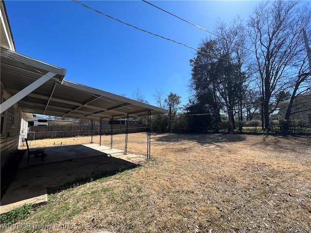 view of yard with fence and driveway