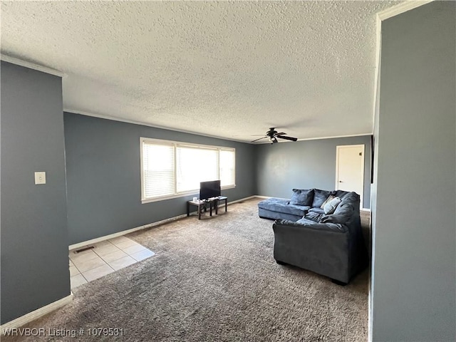 carpeted living area featuring a ceiling fan, baseboards, and a textured ceiling