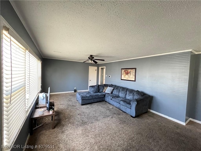 living area with ceiling fan, baseboards, carpet floors, and a textured ceiling